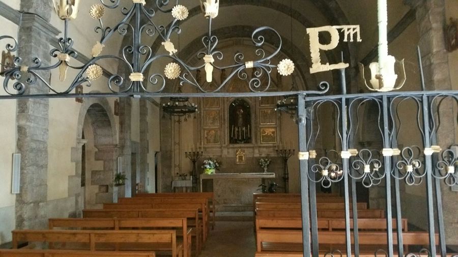 Inside the church of the Santuari de Falgars, with the wrought-iron screen and the altar at the far end