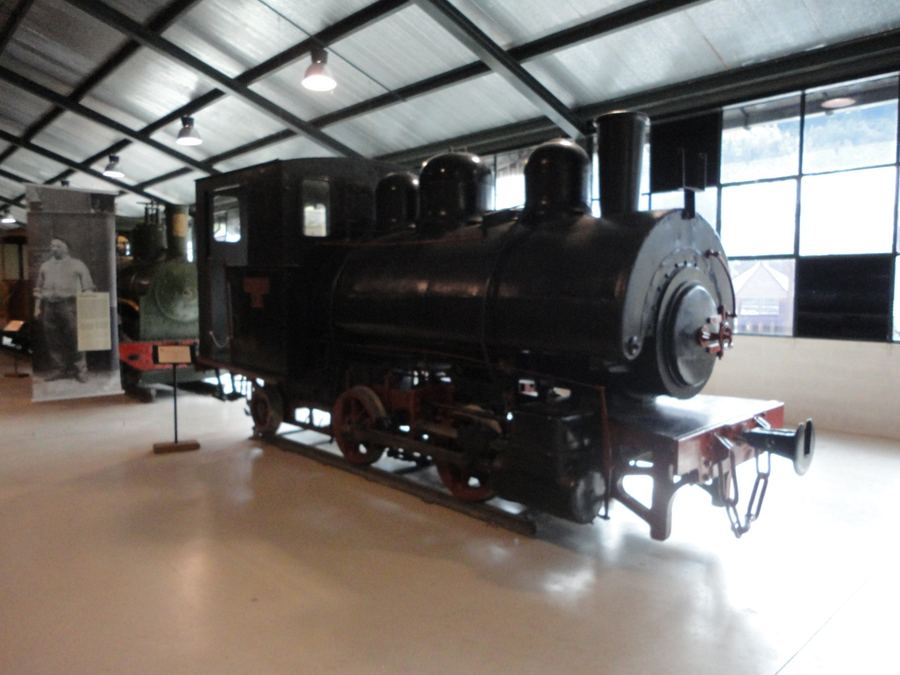 Black steam locomotive with red wheels in the Tren del Ciment museum, La Pobla de Lillet