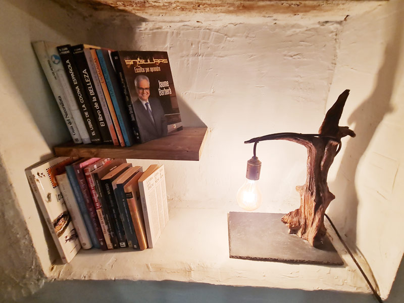 Tríplex Cal Barraqué de Dalt en Borredà - estante de libros con lámpara artesanal
